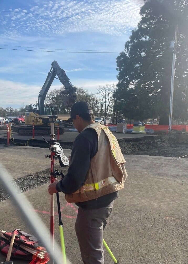 KLS surveyor collecting field data at an active construction site