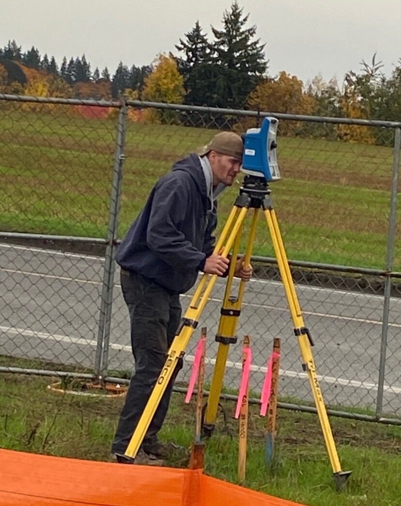 KLS surveyor operating a total station near a public project